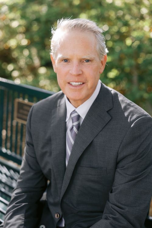 Scott Brandon seated outdoors in a suit, in the press photograph accompanying his Brookgreen Gardens chair appointment