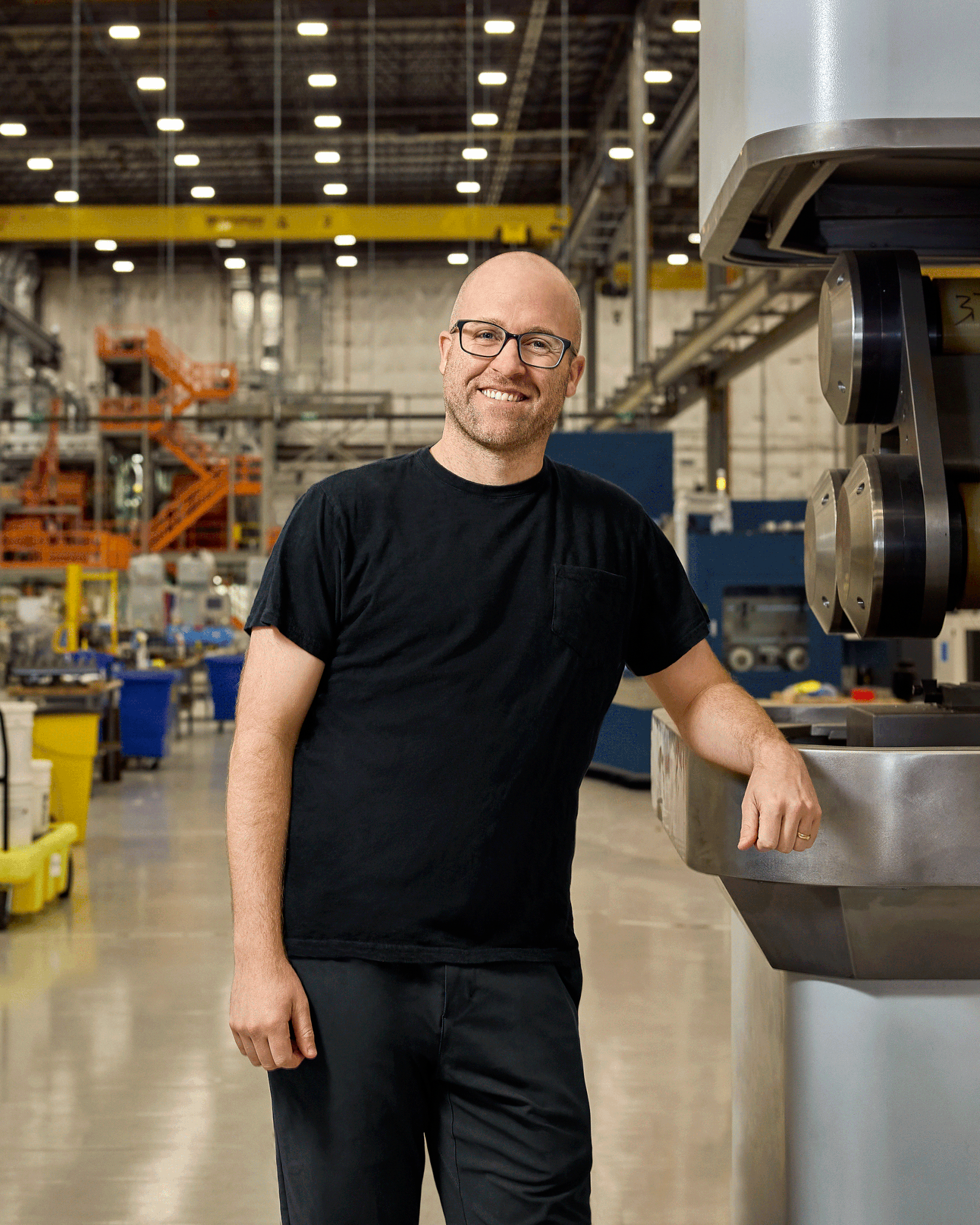 Scott Dunn beside manufacturing equipment inside Noveon’s San Marcos factory