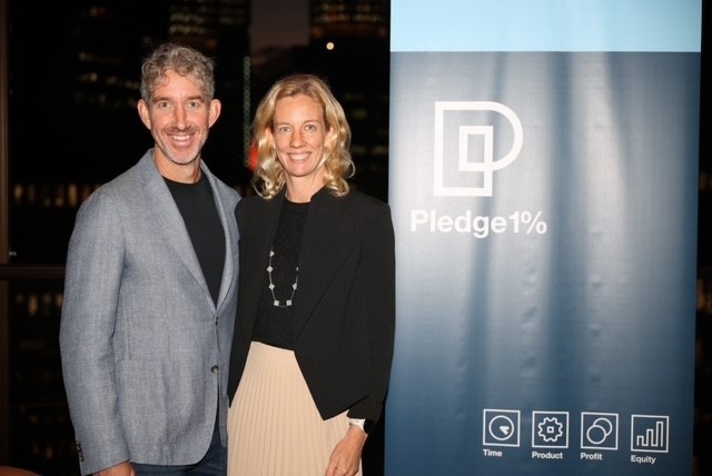 Scott Farquhar and Kim Jackson beside a Pledge 1% banner