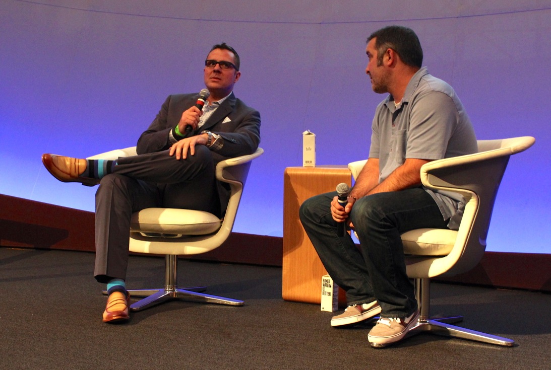 Scott Kveton, left, holding a microphone during a seated interview with Rick Turoczy at TechFestNW