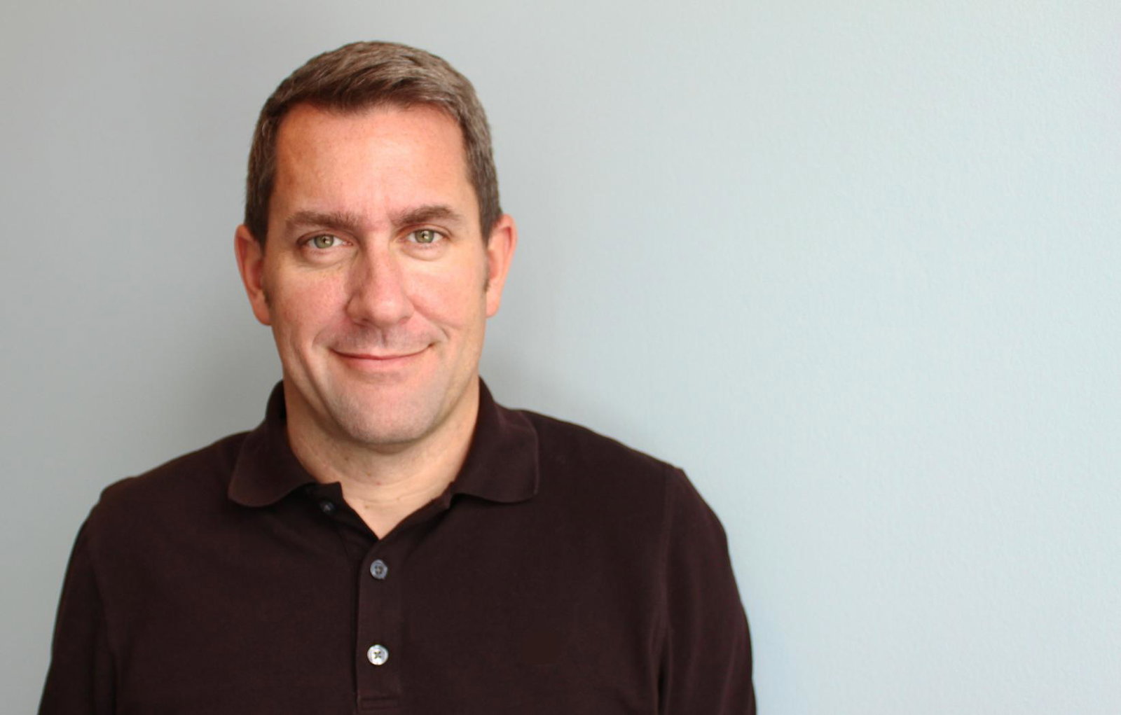 Scott Lake in a black polo shirt, in a photograph shared on his about.me profile