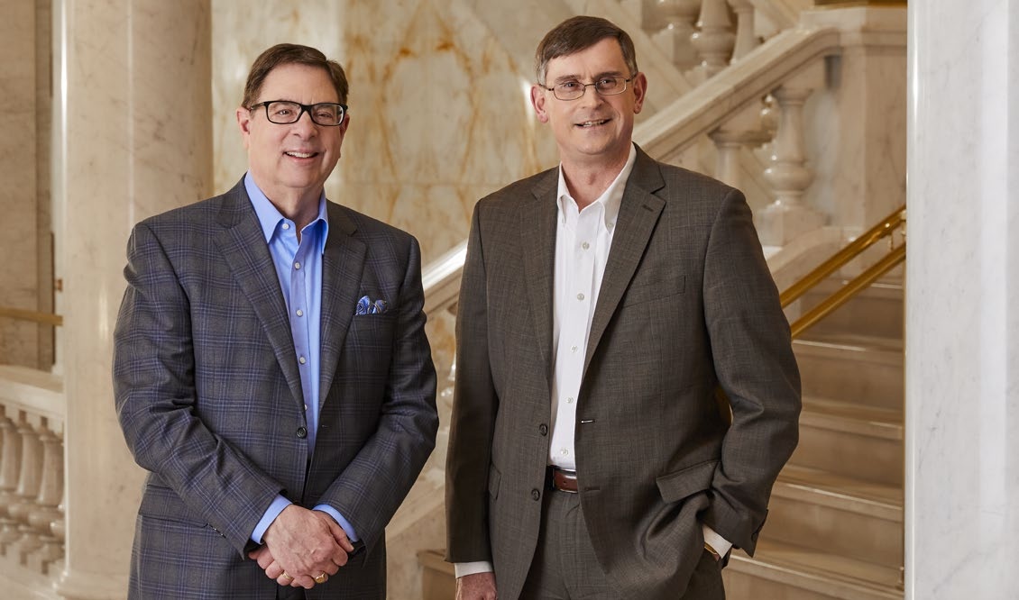 Gale Klappa, left, and Scott Lauber standing beside a marble staircase