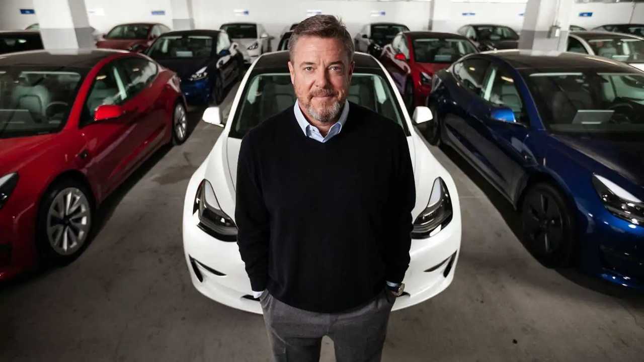 Scott Painter standing among Tesla Model 3 vehicles in an Autonomy garage