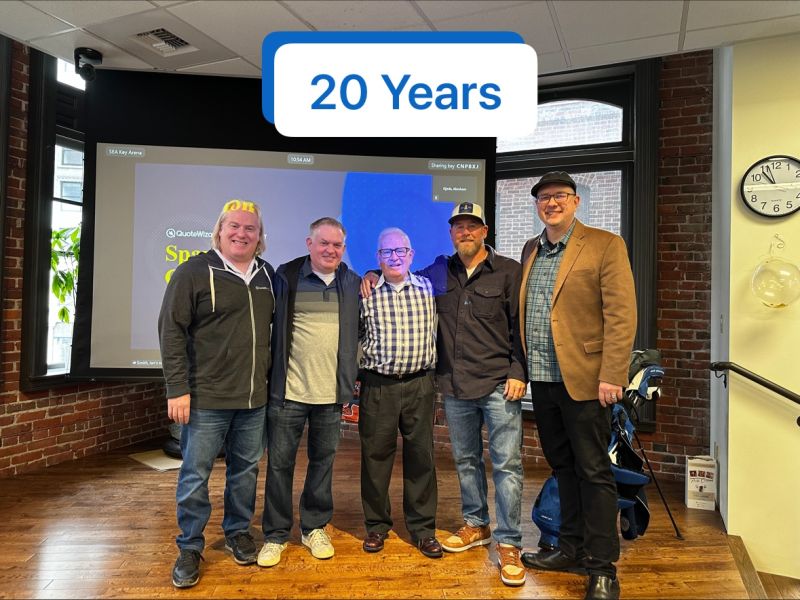 QuoteWizard reunion group with Scott Peyree and fellow founders in a brick-walled office