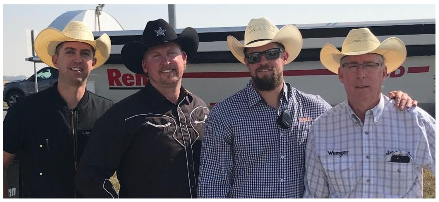 Ryan, Jason, Scott and Monty Sailer wearing cowboy hats in front of a Renn trailer