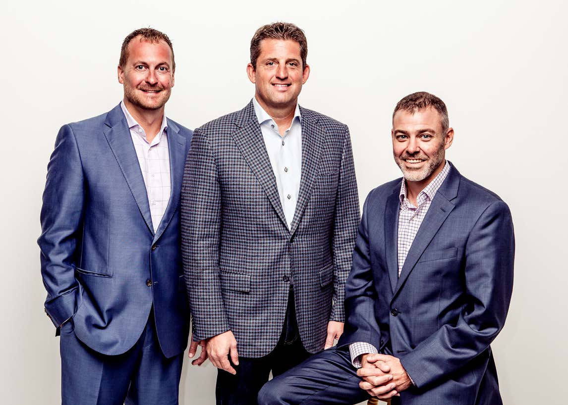 Abstrakt co-founders Brian Condon, Scott Scully and Jason Bahnak pose together in suits