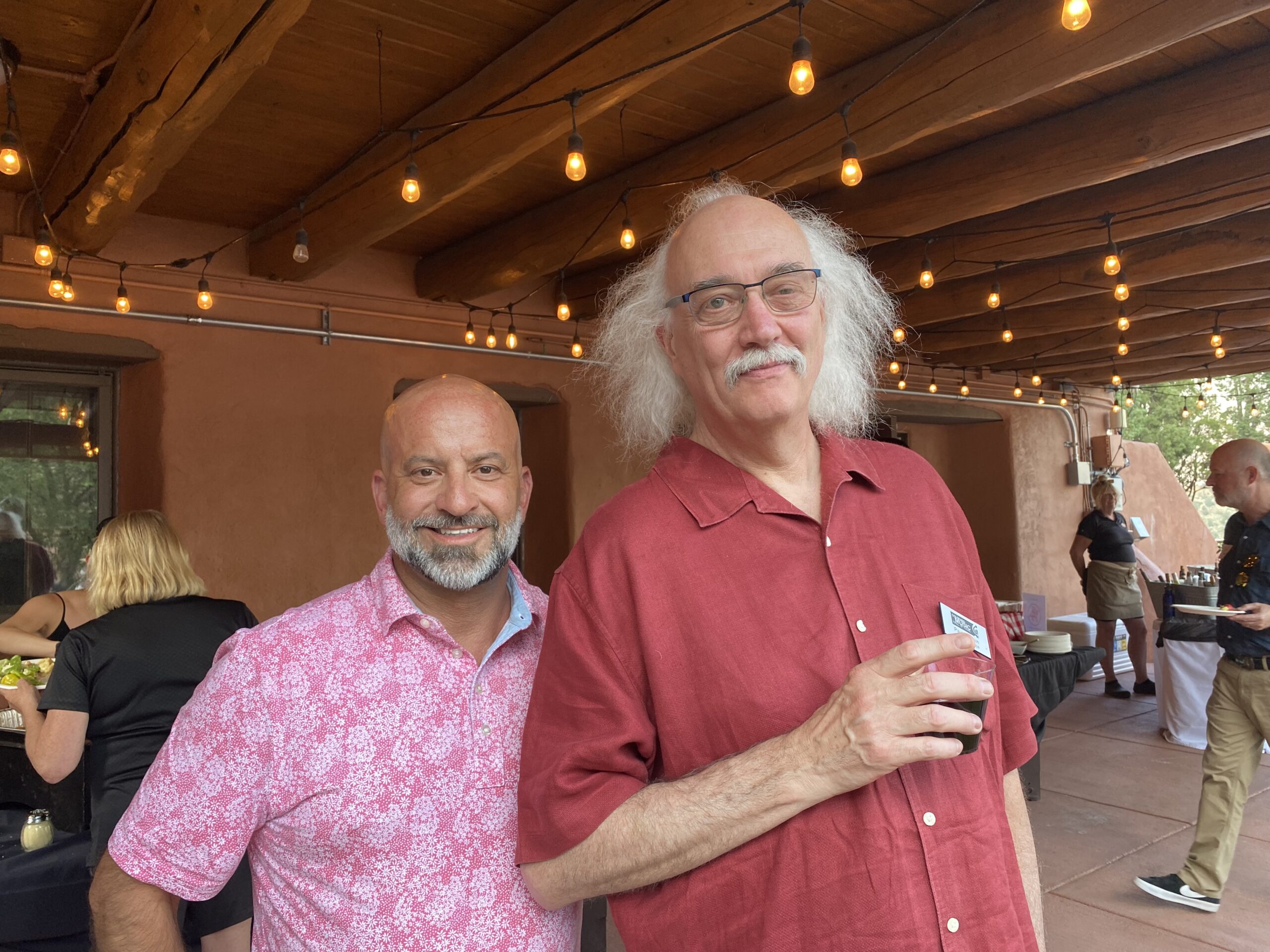 Scott Tobias, left, in a pink patterned shirt, beside Paul Epstein at a Colorado Music Hall of Fame gathering.