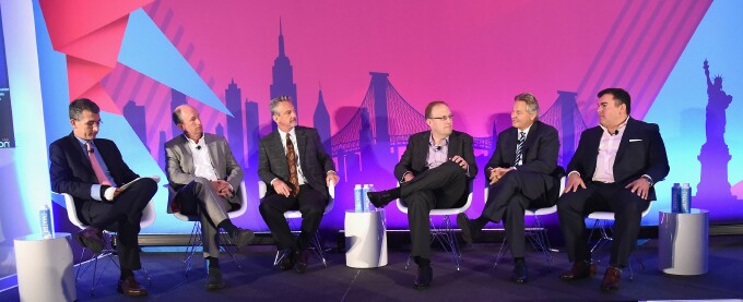 Six media executives seated on an Advertising Week stage; Scott Wells is fourth from the left.