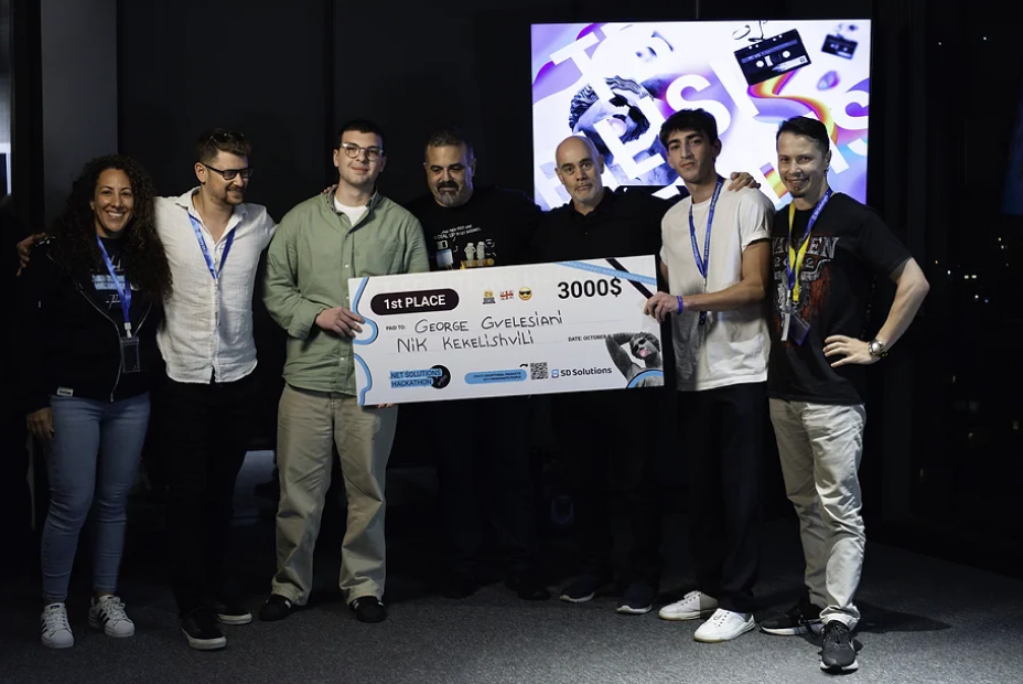 First-place winners and event participants hold a $3,000 prize check at the Tbilisi .NET hackathon