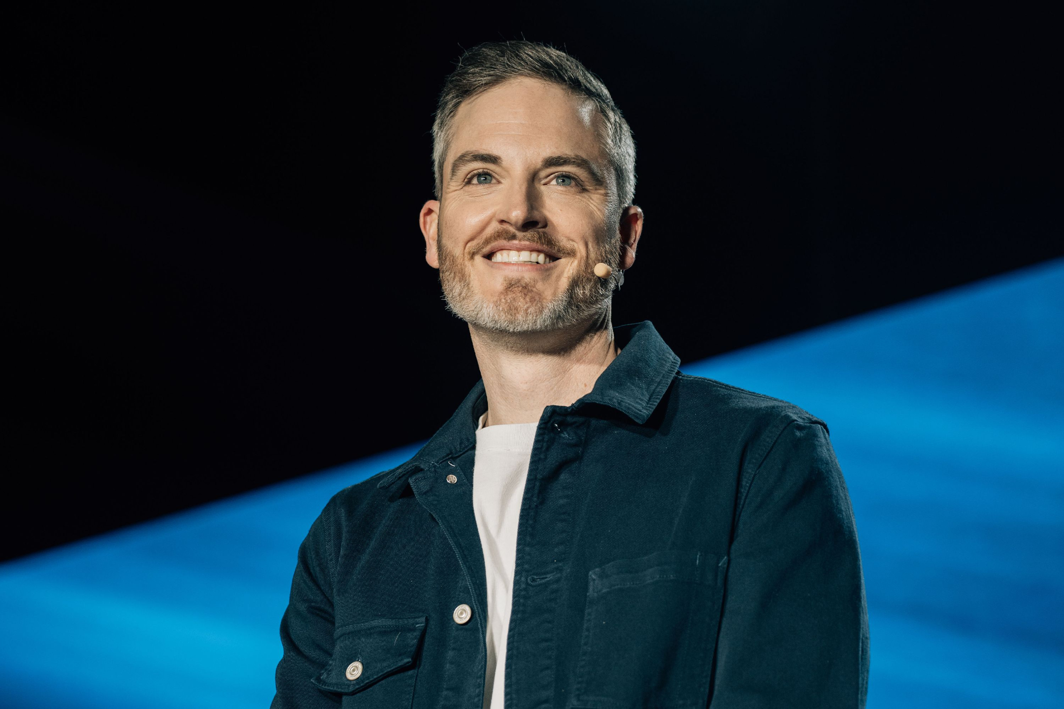 Sean Cannell speaking onstage with a headset microphone