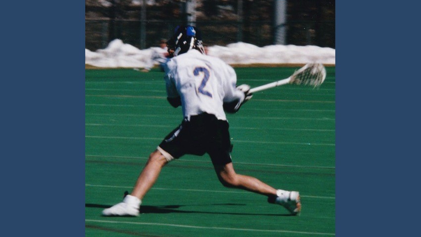 Archival photograph of Sean Rotermund, wearing Bentley lacrosse number 2, taking a shot on the field