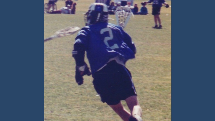Sean Rotermund in an archival Bentley lacrosse photograph, wearing a blue number 2 jersey