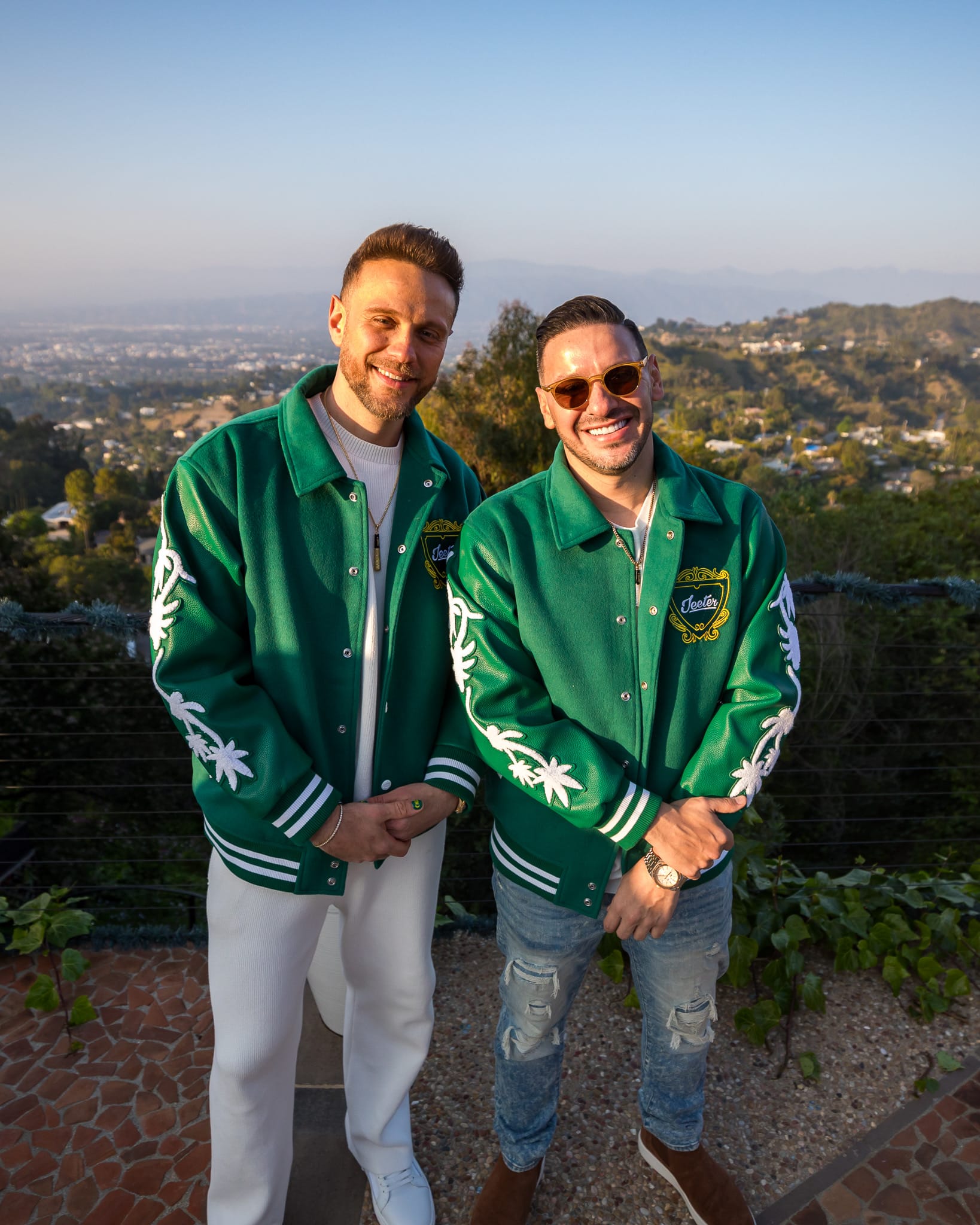 Jeeter co-founders Lukasz Tracz and Sebastian Solano wearing matching green jackets outdoors