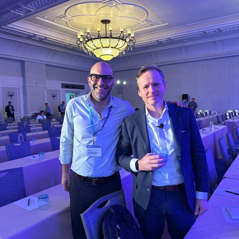SecurityScorecard co-founder Sam Kassoumeh standing beside cybersecurity journalist Brian Krebs at the Odyssey conference