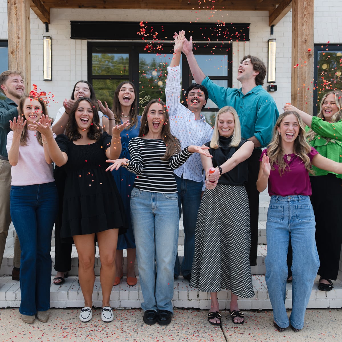 Members of the See Spark Go team celebrating outside an office