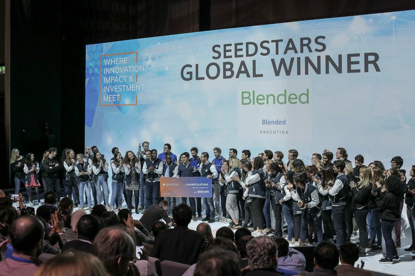 Seedstars competition participants onstage applauding the global winner, Blended