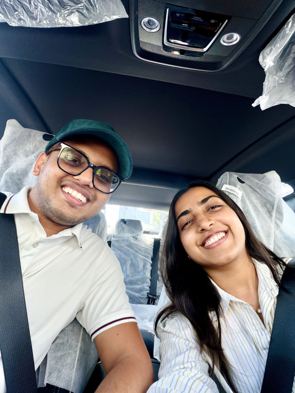 Sehan Sanjula and Thimasha Pathirana smiling inside a new car