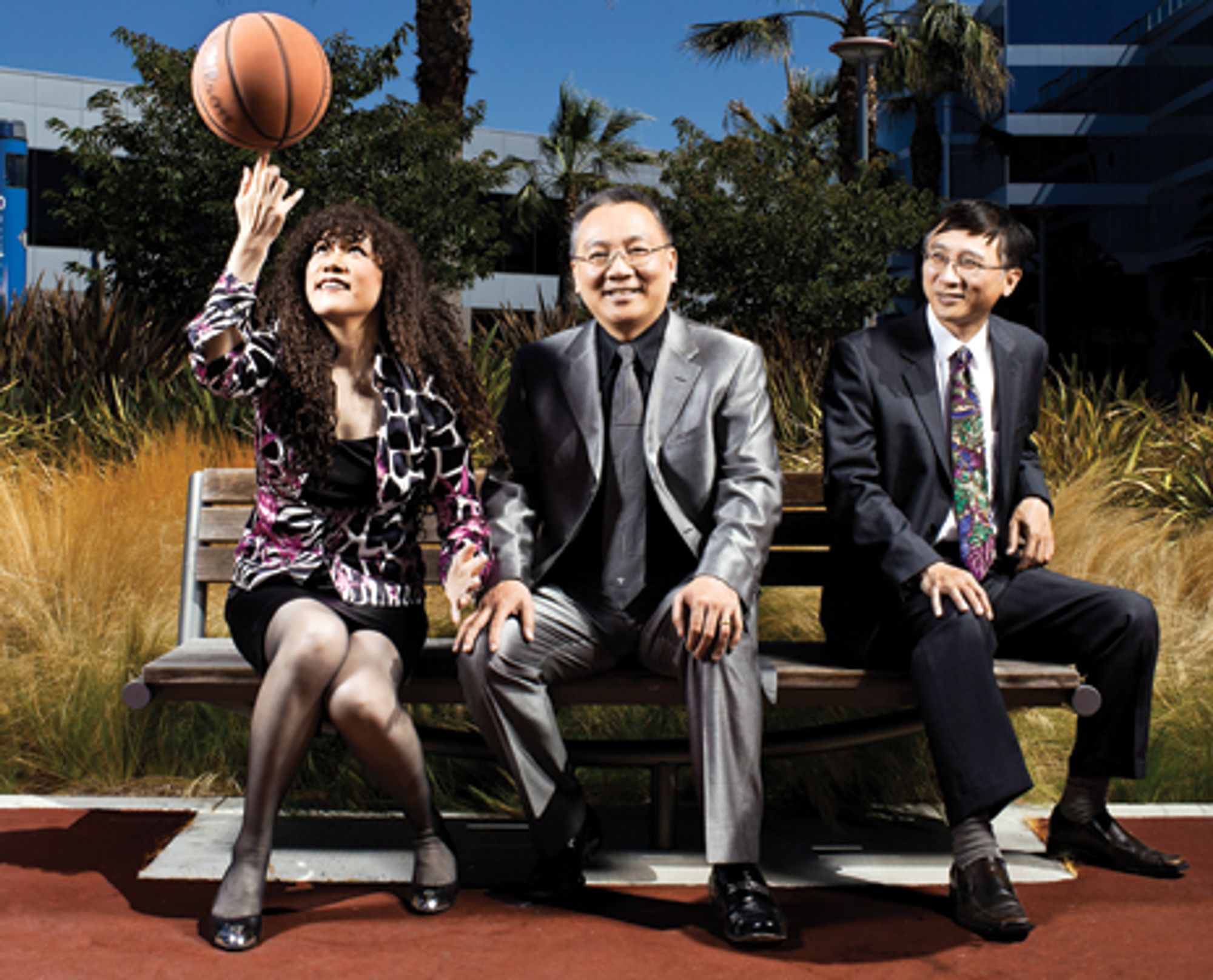 Weili Dai spinning a basketball beside Sehat and Pantas Sutardja on a bench at Marvell