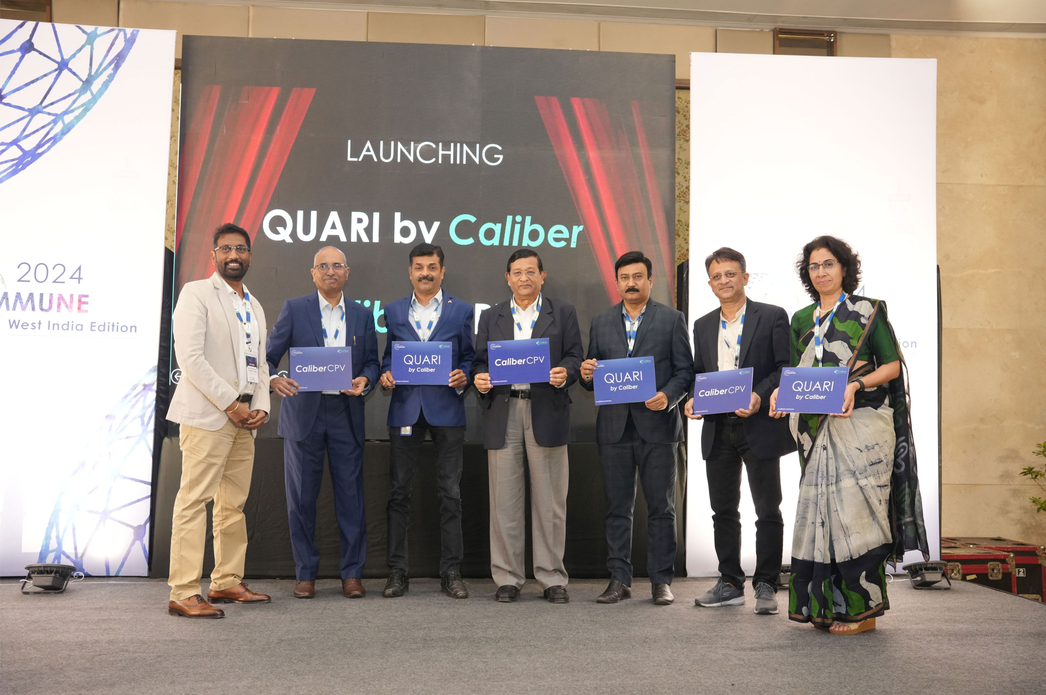 Sekhar Surabhi, second from left, with fellow attendees presenting QUARI and CaliberCPV at Caliber Commune 2024