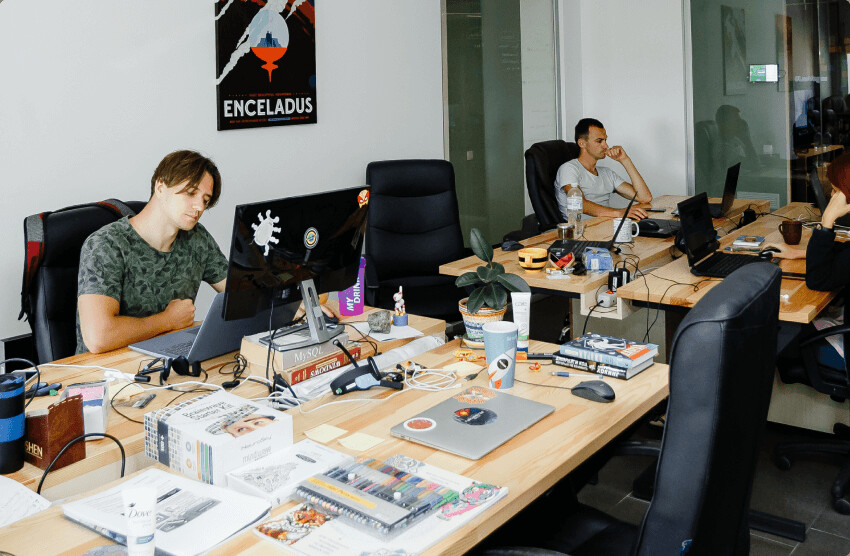 SendPulse team members working in an open office