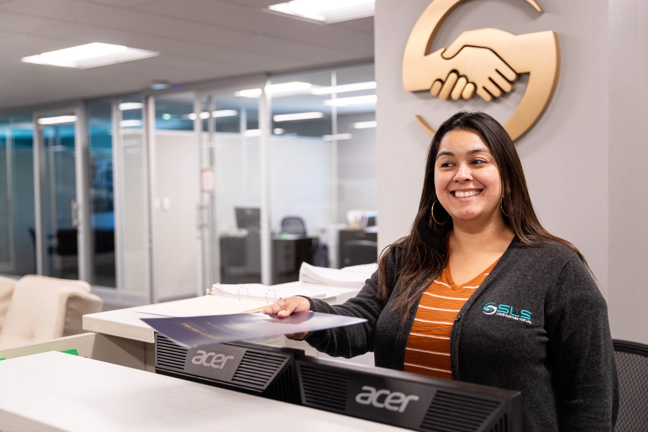SLS reception area with an employee behind the desk