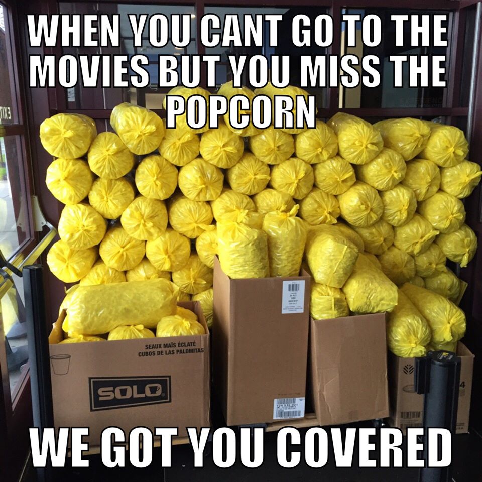 Bags of yellow-packaged movie-theater popcorn stacked for takeaway in a Dipson Theatres promotion