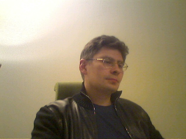 Sergey Dmitriev seated in the Prague office in March 2003
