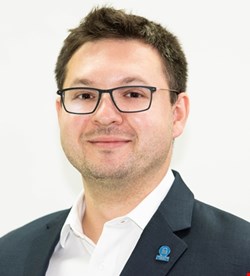 Sergey Gulyayev in a suit and glasses during his time as SecureData COO