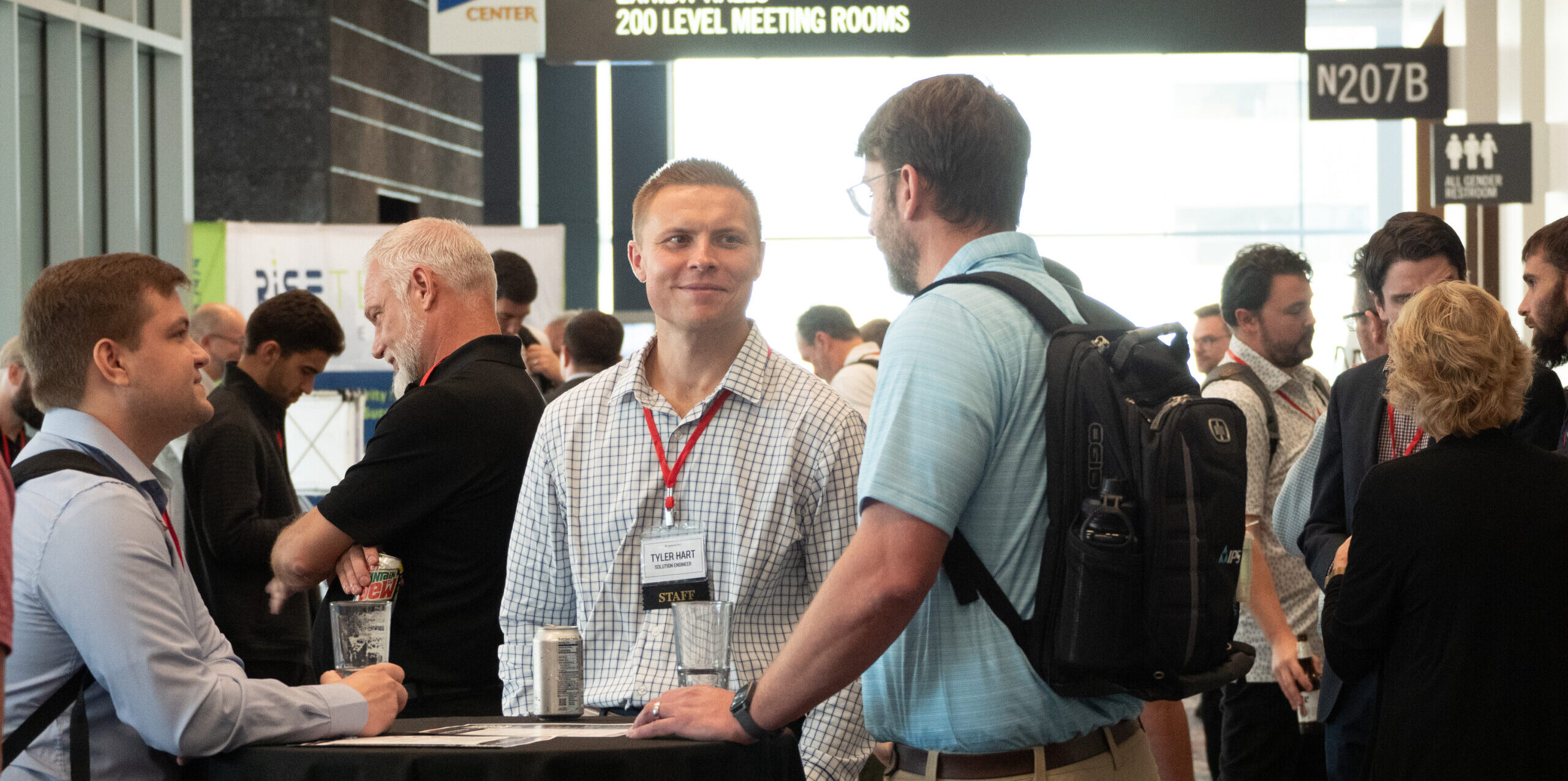 Service Pro team members and customers talking at a company conference