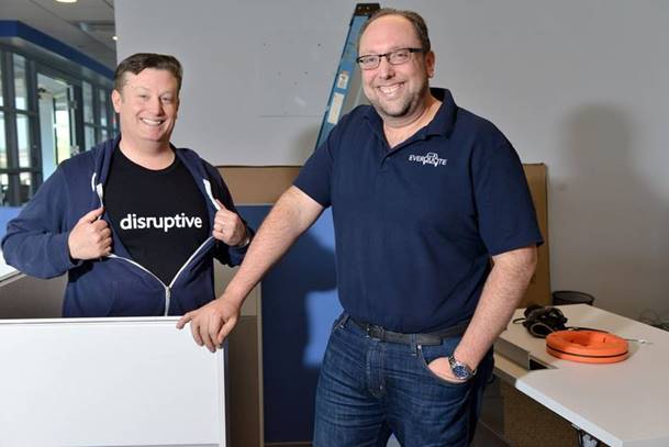 Seth Birnbaum, left, and Tomas Revesz smiling in their office