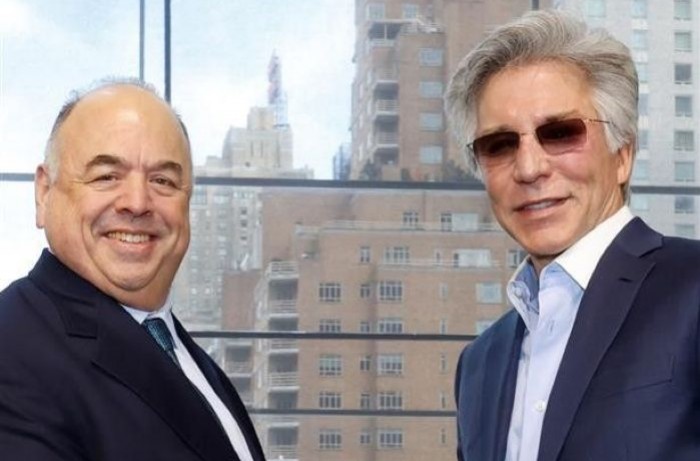 Seth Ravin, left, standing beside ServiceNow CEO Bill McDermott.