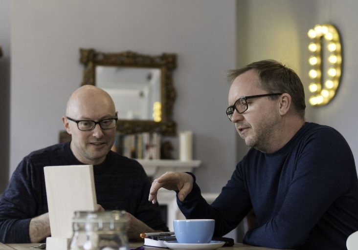 Two people review documents together at a table in a SETsquared Bristol mentoring photograph