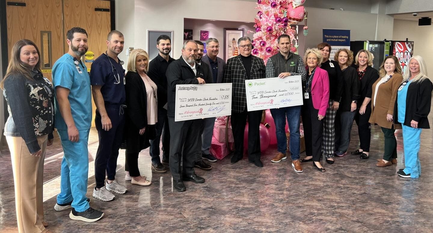 Seve Astorg, Ken Wilkinson, Paul Astorg and Camden Clark Foundation staff holding donation checks in 2023