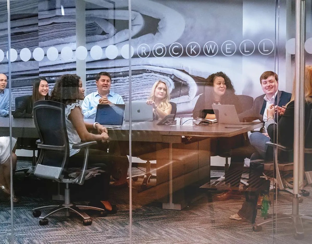Seven Letter colleagues in discussion around a conference table