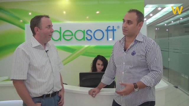 Seyhun Özkara, on the right, speaking during a visit to IdeaSoft’s office