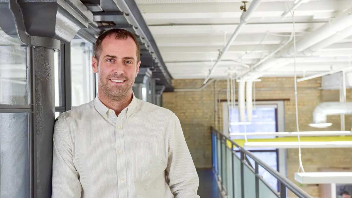 Sezzle co-founder Charlie Youakim standing in an office