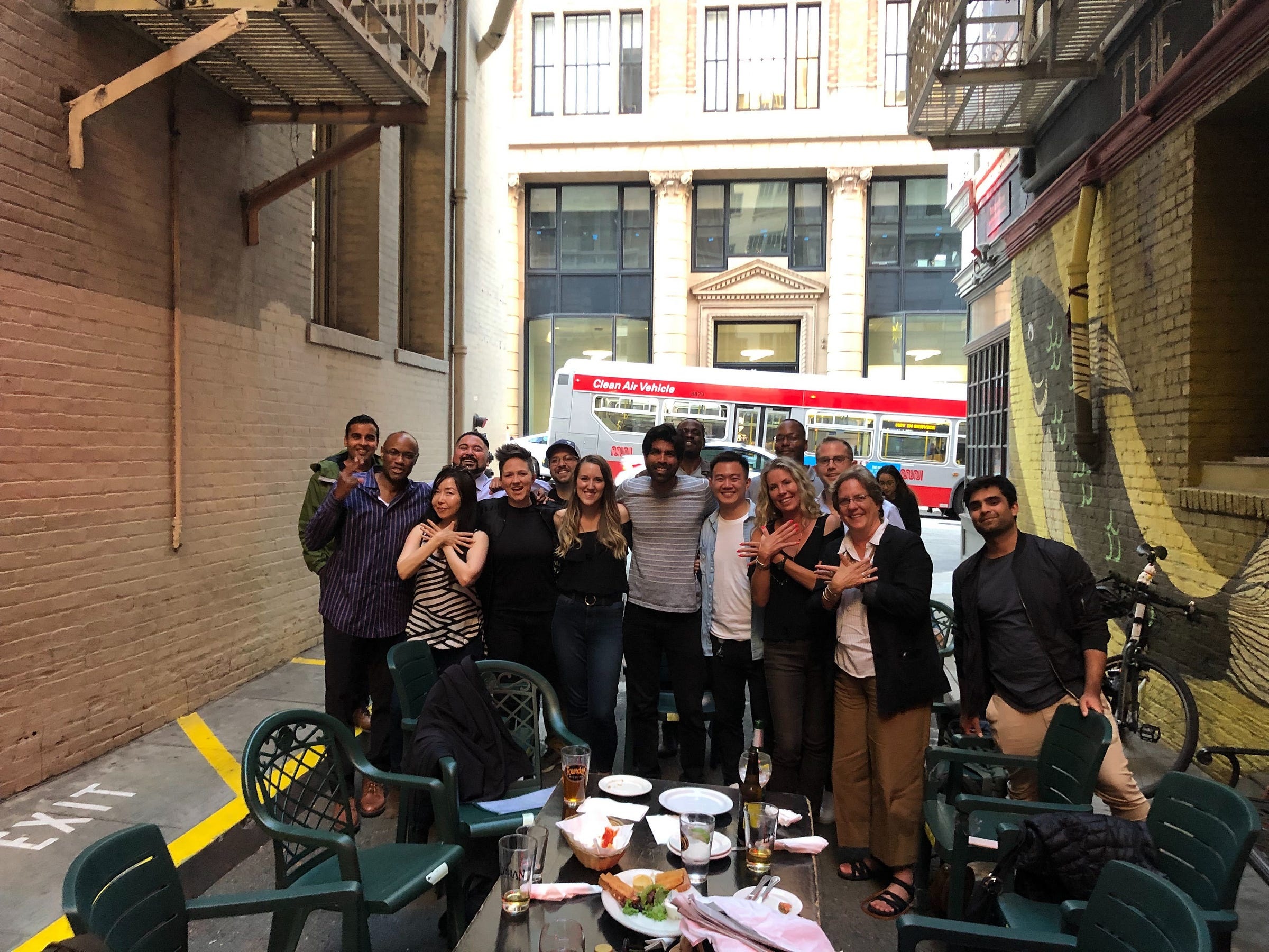 Shaan Hathiramani, near the center in a striped shirt, with Flockjay community members at an outdoor San Francisco gathering