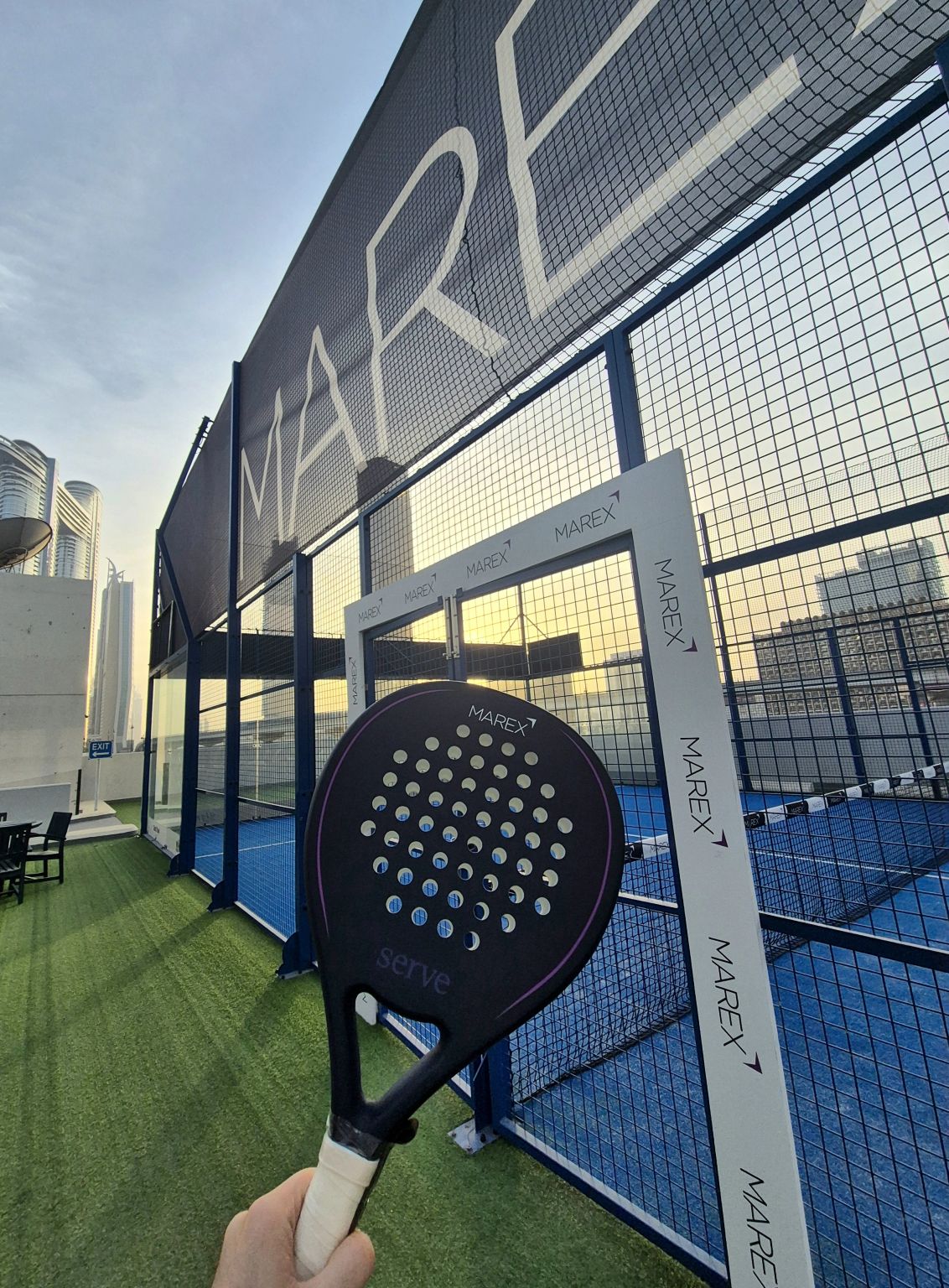 A racket in front of a Marex-branded padel court in DIFC, photographed in a post shared by Shahab Hashemi