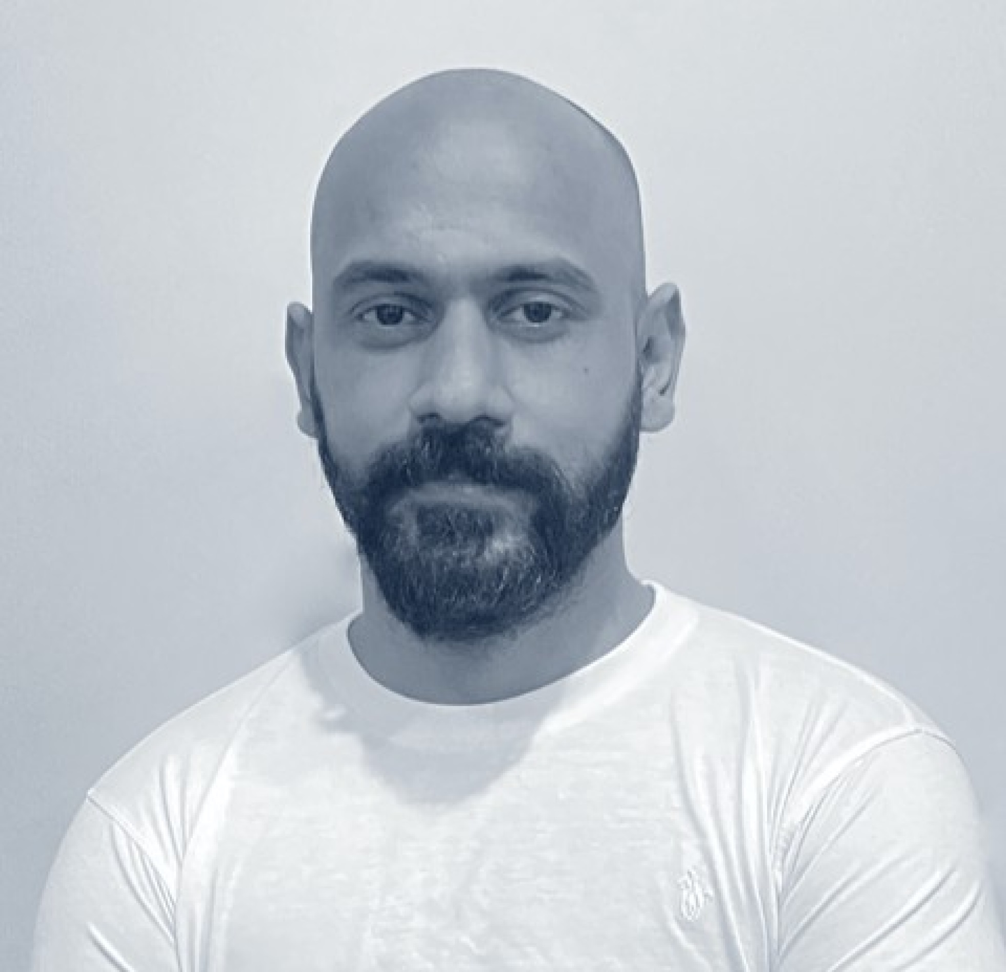 An archival photograph of Shahid Hanif wearing a white T-shirt