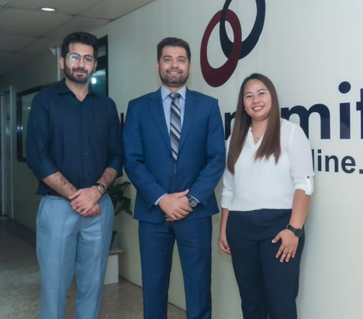 Shahzad Yaqoob, center, standing with two IdeasUnlimited colleagues
