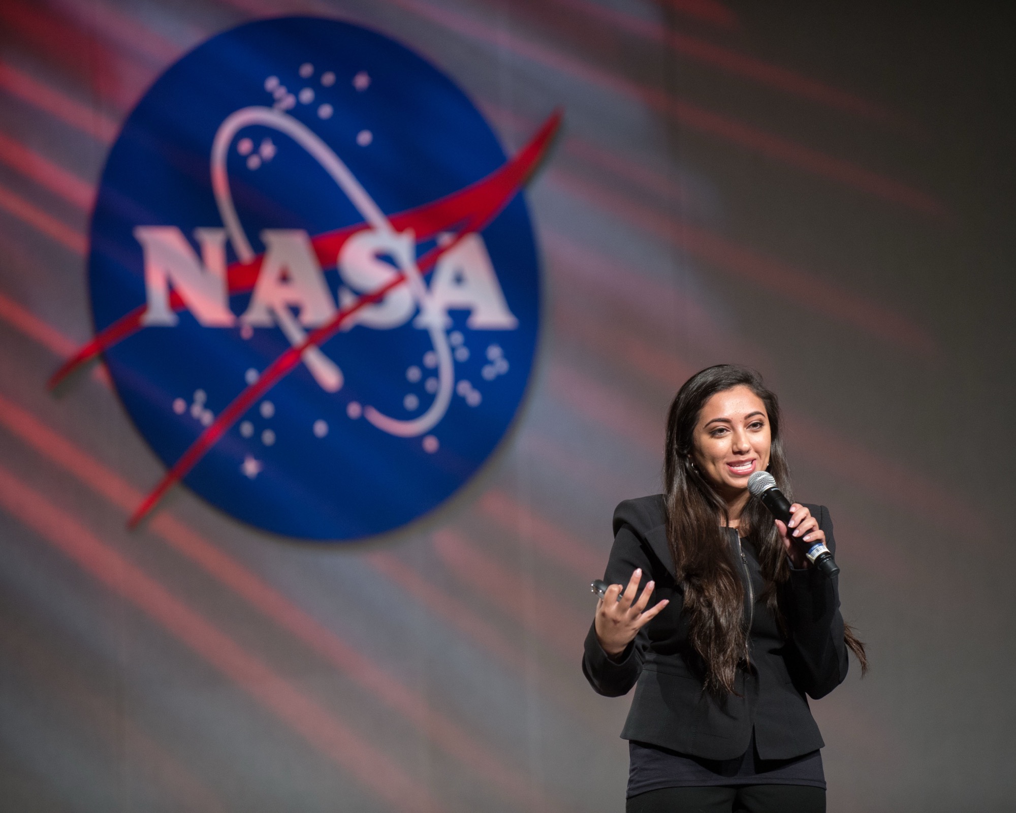 Shama Hyder delivering a keynote during a NASA event