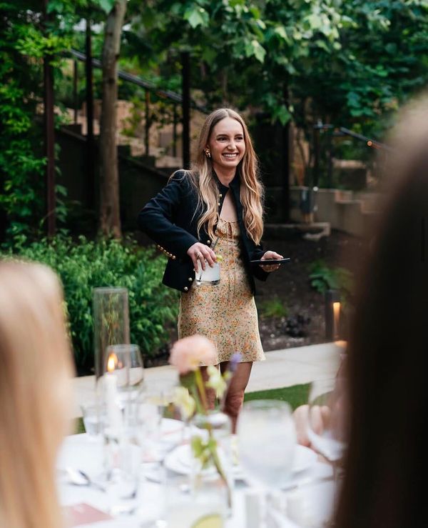 Shana Davis-Ross smiling beside an outdoor dining table