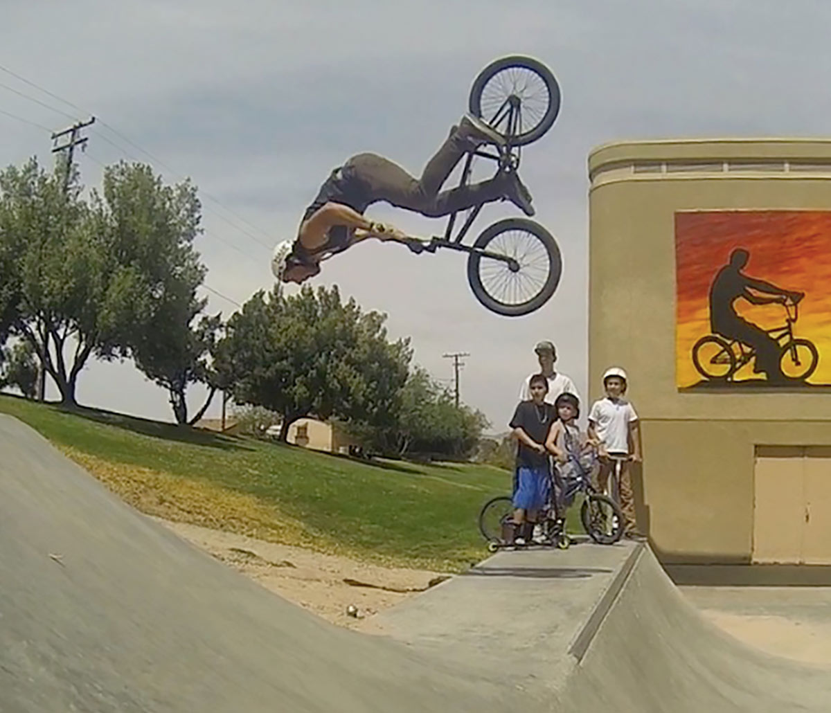 Shane Michael performing a BMX backflip above a ramp