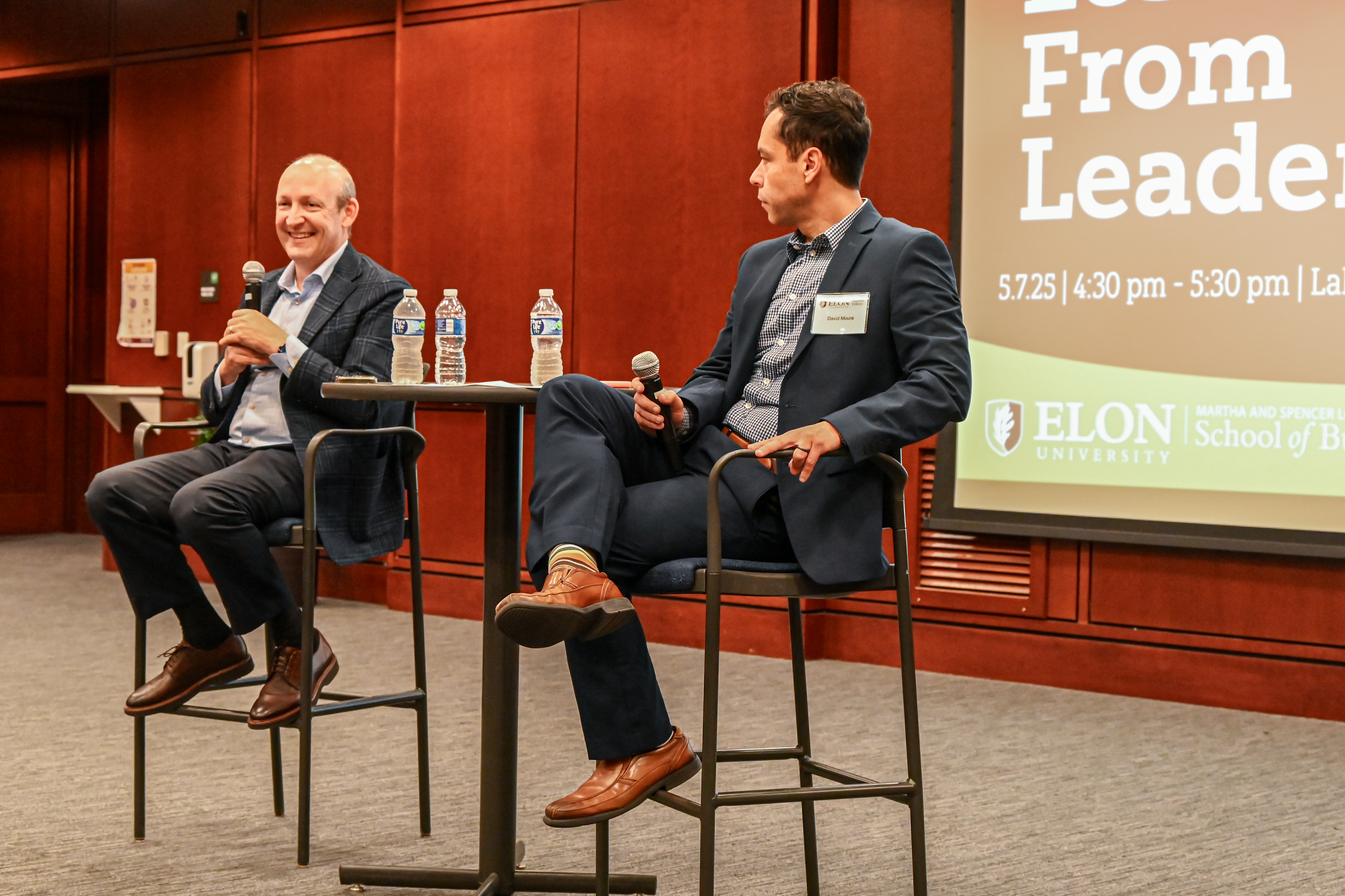 Shane O’Kelly, left, speaking with lecturer David Moura at Elon University’s Lessons from Leaders event