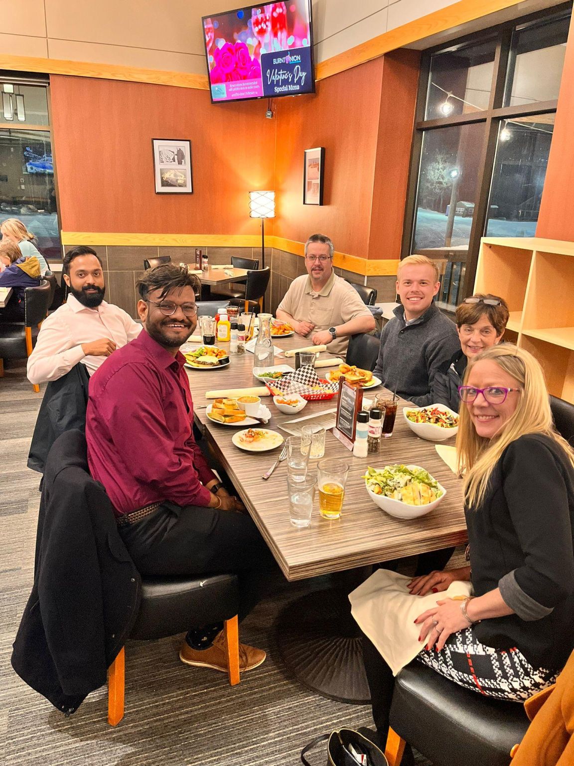 Shani Bhavsar and colleagues sharing a restaurant table during Dash’s Arrowhead Transit visit