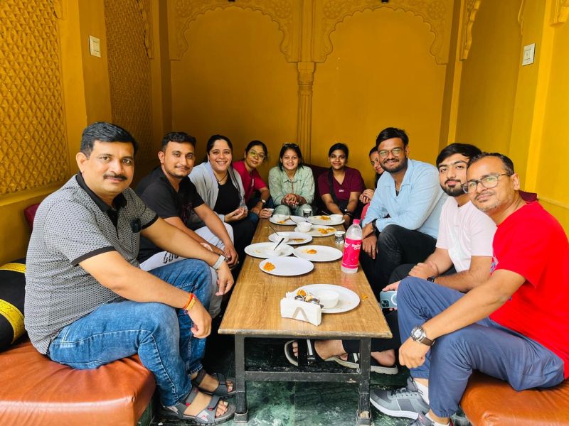 Shani Bhavsar with Dash colleagues around a lunch table during the team’s Udaipur outing