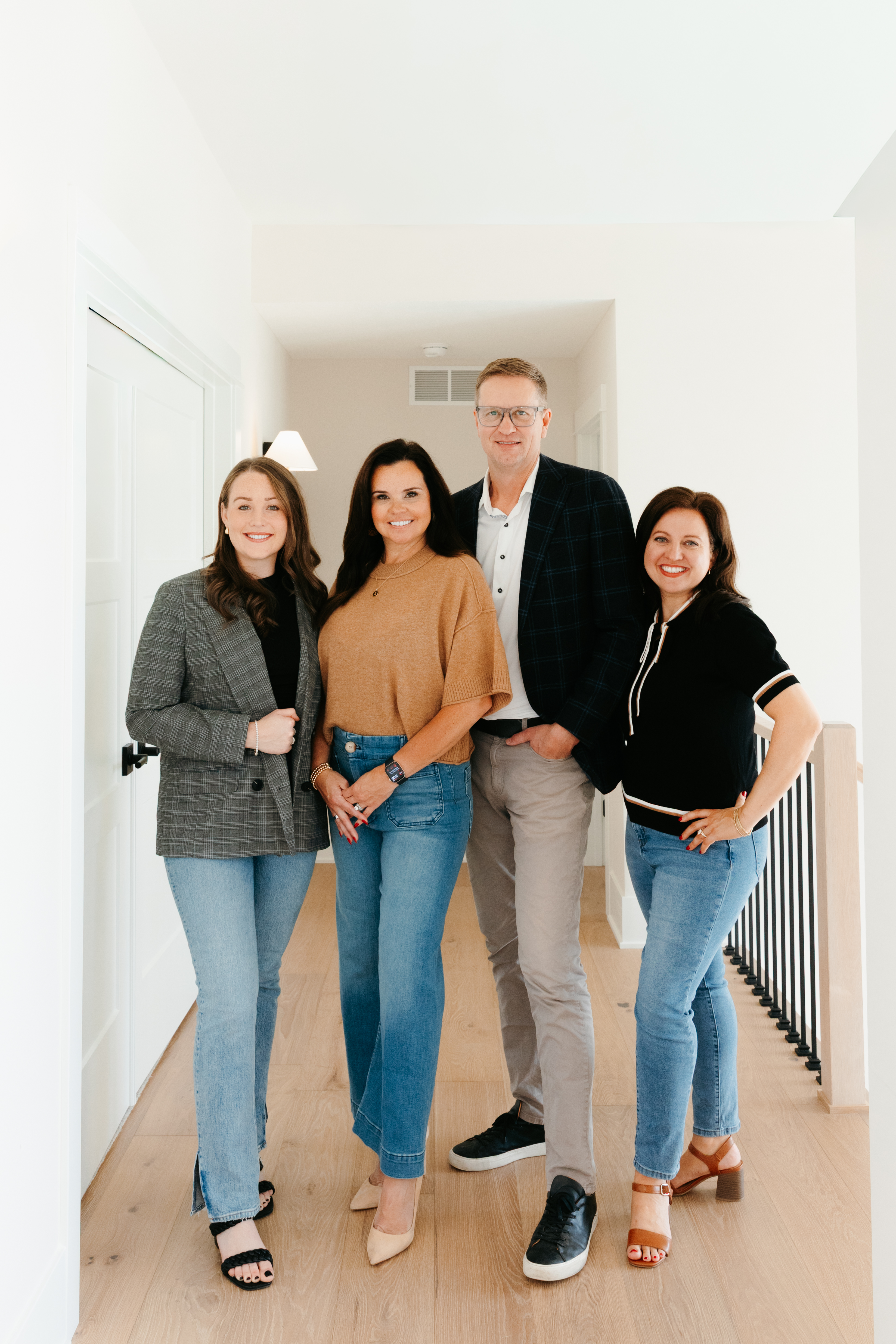 The four Brooks Team agents standing together in a bright home hallway