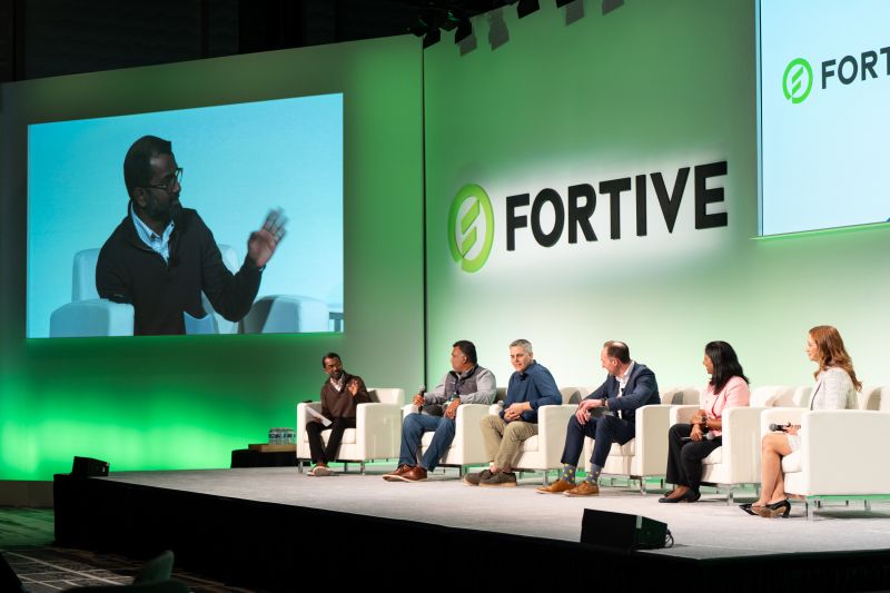 A panel discussion on a Fortive conference stage, with Sharon Lubrano seated at the far right