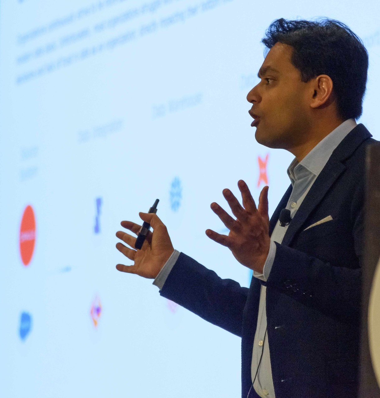 Shashank Saxena speaking with a presentation remote at the University of Cincinnati Analytics Summit