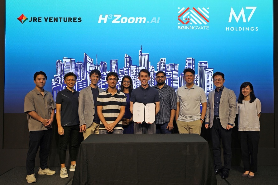 Shaun Koo stands at the centre of a group with H3 Zoom colleagues and investor representatives